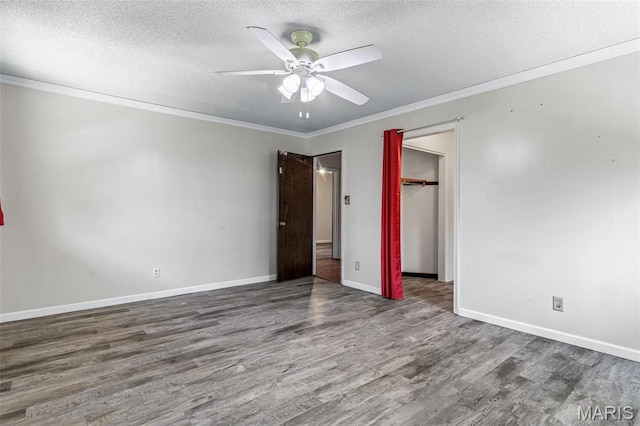 10179 Cherry Hill Ln, Potosi, MO 63664 - unfurnished bedroom with wood finished floors, ornamental molding, a textured ceiling, baseboards, and a closet