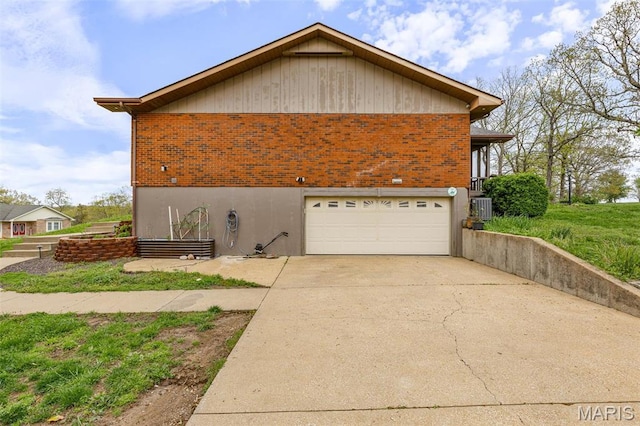 1304 Napoleon Dr, Bonne Terre, MO 63628 - view of side of property with brick siding, an attached garage, cooling unit, and driveway
