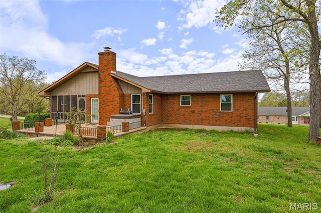 1304 Napoleon Dr, Bonne Terre, MO 63628 - back of property with a sunroom, a chimney, brick siding, a yard, and a shingled roof