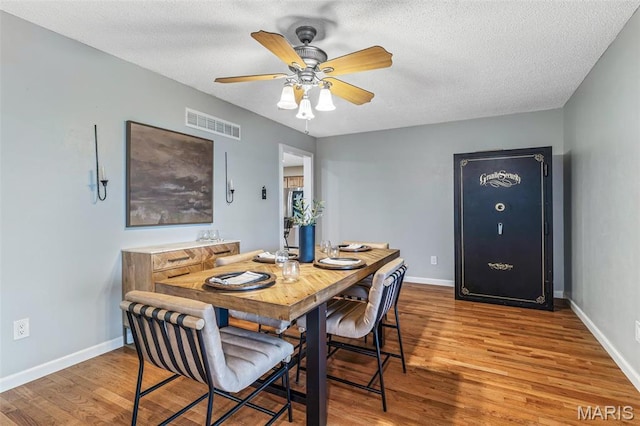 1304 Napoleon Dr, Bonne Terre, MO 63628 - dining space with wood finished floors, baseboards, and a textured ceiling