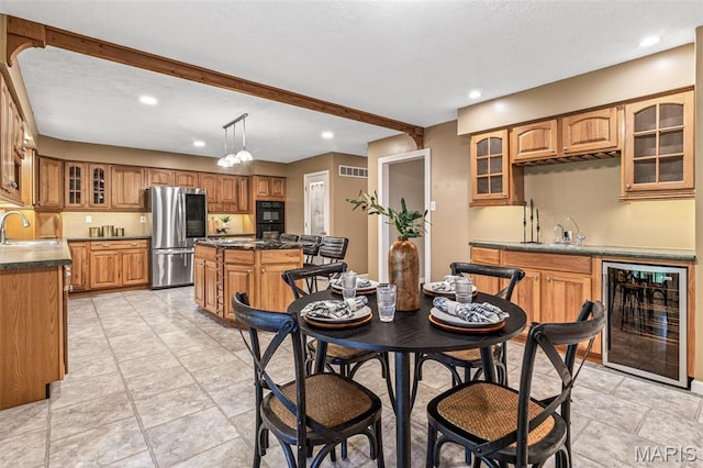 1304 Napoleon Dr, Bonne Terre, MO 63628 - dining area with beverage cooler, wet bar, recessed lighting, and beamed ceiling