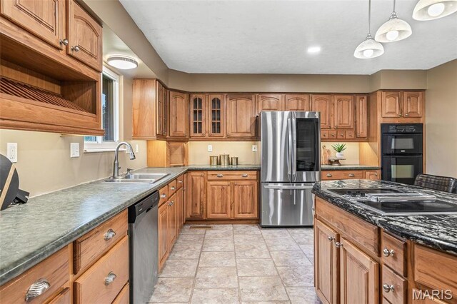1304 Napoleon Dr, Bonne Terre, MO 63628 - kitchen with black appliances, a sink, brown cabinets, and dark countertops
