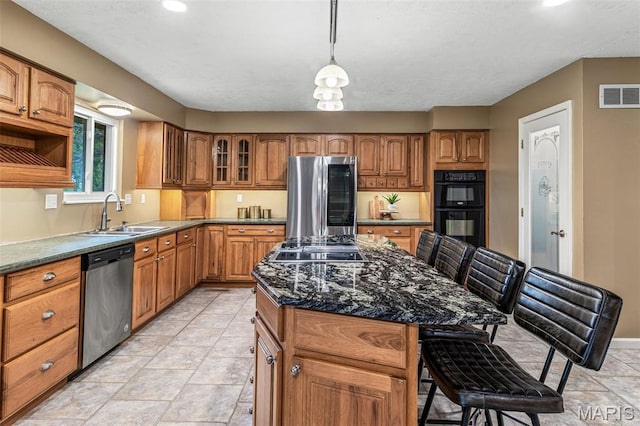 1304 Napoleon Dr, Bonne Terre, MO 63628 - kitchen featuring black appliances, a sink, brown cabinetry, a kitchen island, and recessed lighting