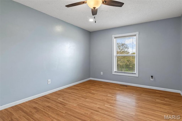 1304 Napoleon Dr, Bonne Terre, MO 63628 - spare room with a ceiling fan, a textured ceiling, light wood-style flooring, and baseboards