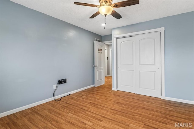 1304 Napoleon Dr, Bonne Terre, MO 63628 - unfurnished bedroom with light wood-type flooring, baseboards, a textured ceiling, a closet, and ceiling fan