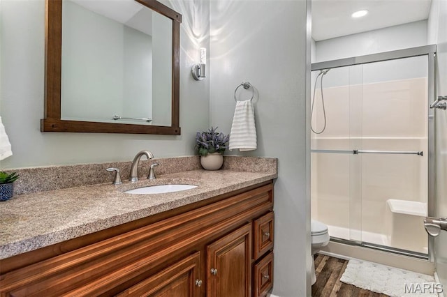 1304 Napoleon Dr, Bonne Terre, MO 63628 - bathroom featuring toilet, a stall shower, vanity, and wood finished floors