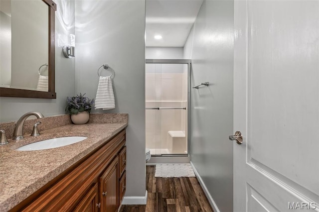 1304 Napoleon Dr, Bonne Terre, MO 63628 - bathroom with wood finished floors, a stall shower, vanity, toilet, and baseboards
