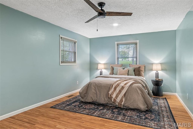 1304 Napoleon Dr, Bonne Terre, MO 63628 - bedroom featuring wood finished floors, a textured ceiling, baseboards, and a ceiling fan