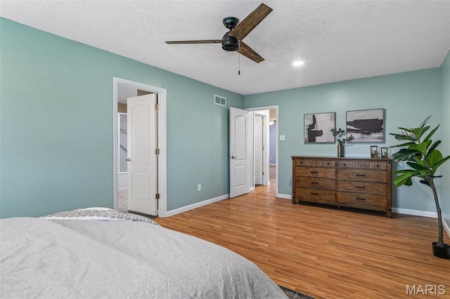 1304 Napoleon Dr, Bonne Terre, MO 63628 - bedroom with wood finished floors, baseboards, a textured ceiling, and a ceiling fan