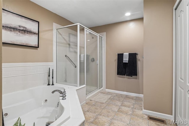 1304 Napoleon Dr, Bonne Terre, MO 63628 - bathroom with a shower stall, a tub with jets, stone tile floors, baseboards, and recessed lighting