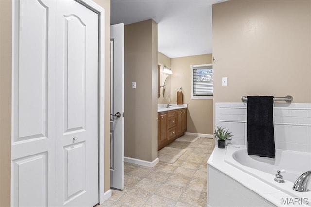 1304 Napoleon Dr, Bonne Terre, MO 63628 - bathroom featuring baseboards, vanity, and a garden tub