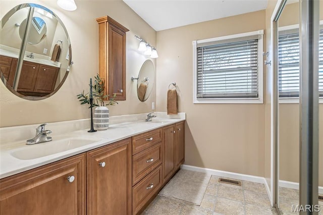 1304 Napoleon Dr, Bonne Terre, MO 63628 - bathroom featuring plenty of natural light, baseboards, and double vanity