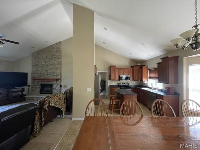 11 Summers Dr, Hawk Point, MO 63349 - dining room featuring lofted ceiling, ceiling fan, a fireplace, and a chandelier