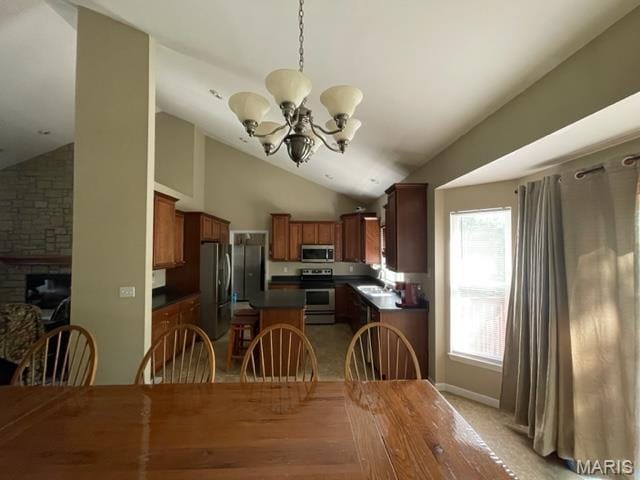 11 Summers Dr, Hawk Point, MO 63349 - dining area featuring a chandelier, lofted ceiling, and a stone fireplace