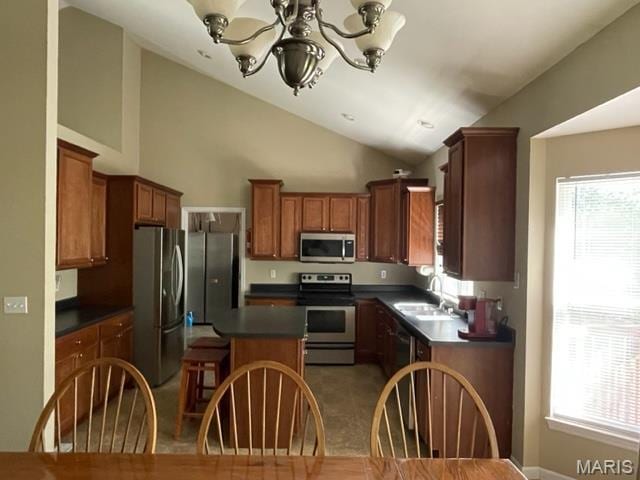 11 Summers Dr, Hawk Point, MO 63349 - kitchen with stainless steel appliances, dark countertops, a sink, a chandelier, and vaulted ceiling