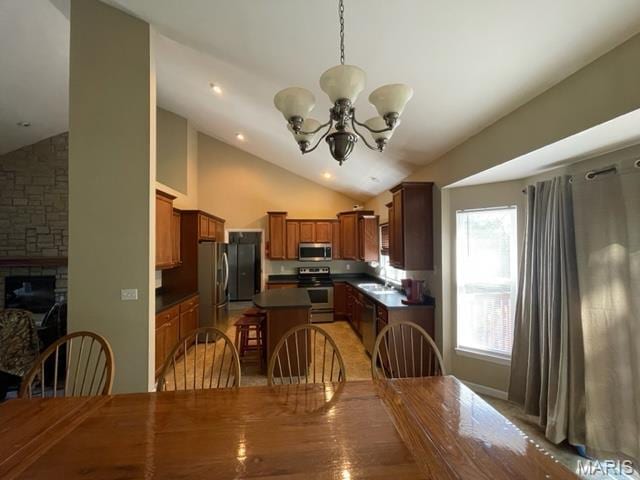 11 Summers Dr, Hawk Point, MO 63349 - dining area with lofted ceiling, a chandelier, and a fireplace