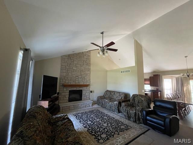 11 Summers Dr, Hawk Point, MO 63349 - living area featuring vaulted ceiling, ceiling fan, and a stone fireplace