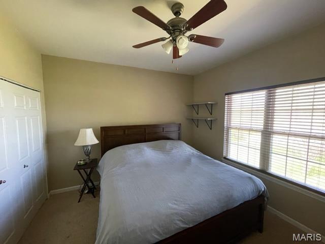 11 Summers Dr, Hawk Point, MO 63349 - bedroom with light colored carpet, baseboards, a closet, and a ceiling fan