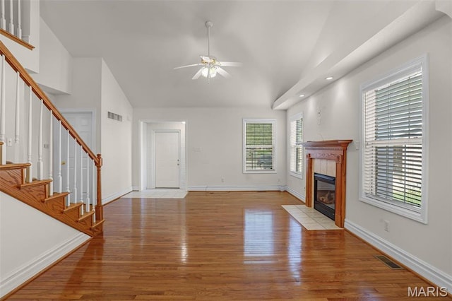 14 Berry Patch Ln, Glen Carbon, IL 62034 - unfurnished living room featuring light wood finished floors, a ceiling fan, stairs, baseboards, and high vaulted ceiling