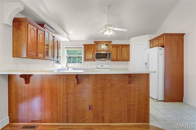 14 Berry Patch Ln, Glen Carbon, IL 62034 - kitchen with stainless steel microwave, white refrigerator with ice dispenser, stove, glass insert cabinets, and a peninsula
