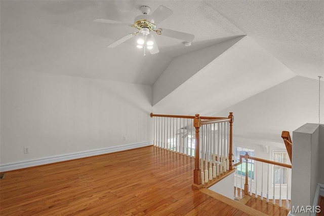 14 Berry Patch Ln, Glen Carbon, IL 62034 - additional living space with ceiling fan, vaulted ceiling, wood finished floors, and baseboards