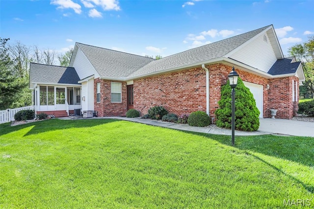 14 Berry Patch Ln, Glen Carbon, IL 62034 - view of front facade featuring a sunroom, an attached garage, brick siding, and roof with shingles