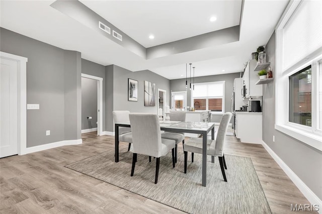 2034 Ann Ave, Saint Louis, MO 63104 - dining area with light wood-type flooring, a tray ceiling, baseboards, and recessed lighting