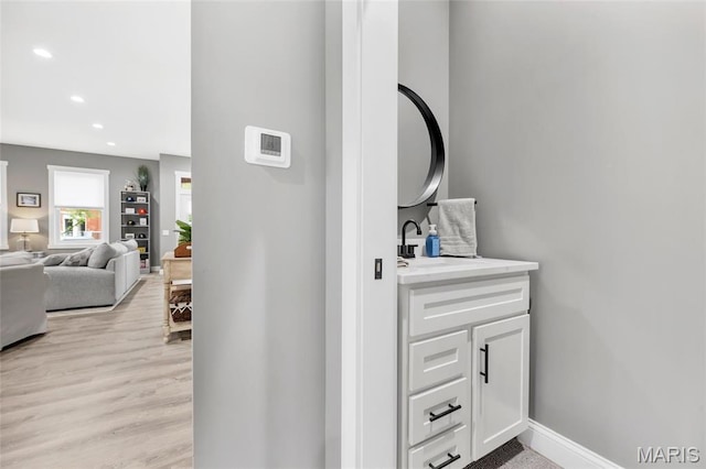 2034 Ann Ave, Saint Louis, MO 63104 - hallway with recessed lighting, baseboards, a sink, and light wood-style floors