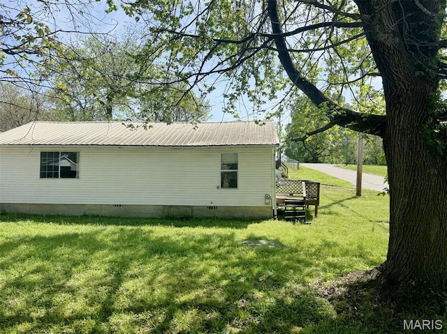 1107 Winnie St, Poplar Bluff, MO 63901 - view of property exterior with crawl space, metal roof, and a lawn
