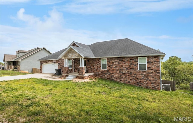 20256 Hardcastle Ln, Saint Robert, MO 65584 - view of front of property featuring a garage, concrete driveway, a front lawn, and cooling unit