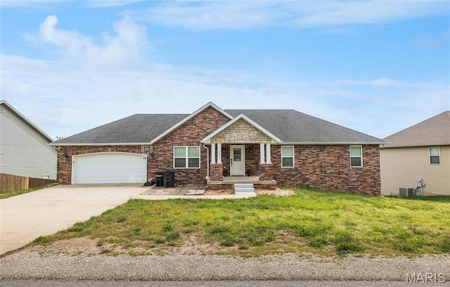 20256 Hardcastle Ln, Saint Robert, MO 65584 - view of front of home featuring an attached garage, concrete driveway, central AC unit, and roof with shingles