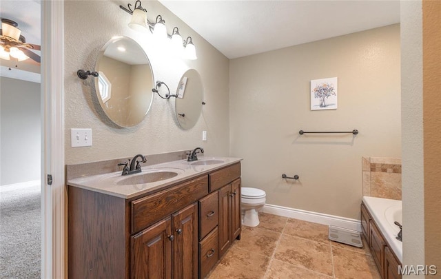 20256 Hardcastle Ln, Saint Robert, MO 65584 - bathroom featuring double vanity, baseboards, ceiling fan, a bath, and toilet