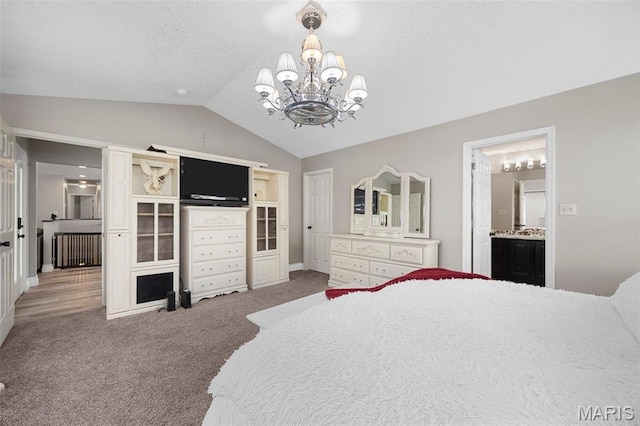 bedroom with lofted ceiling, carpet floors, a chandelier, ensuite bath, and baseboards