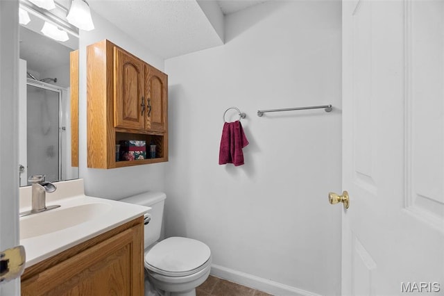 full bath with a stall shower, toilet, vanity, and tile patterned flooring