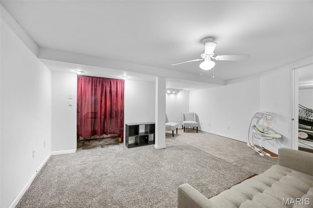 living room featuring carpet, a ceiling fan, and baseboards