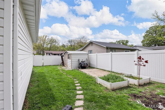 view of yard featuring a garden, a storage shed, and an outdoor structure