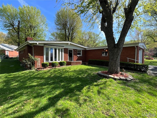 805 Willoway Ave, East Alton, IL 62024 - ranch-style home featuring brick siding, a chimney, and a front yard