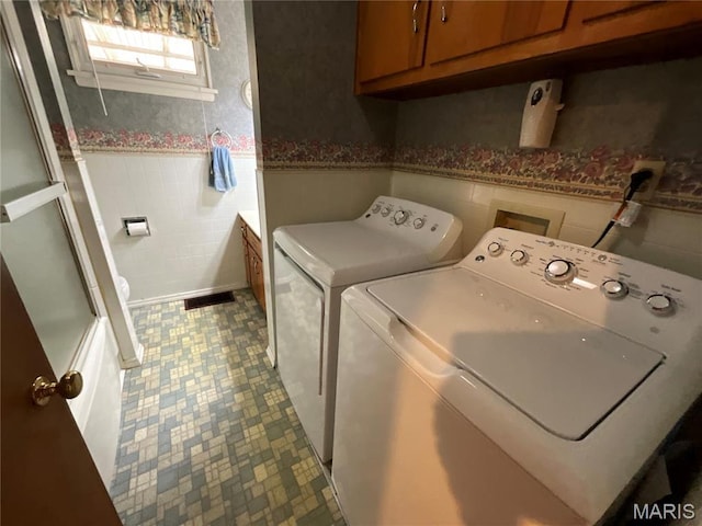 805 Willoway Ave, East Alton, IL 62024 - laundry room featuring washer and clothes dryer, a wainscoted wall, and cabinet space