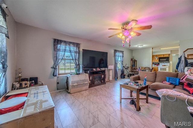 living room featuring ceiling fan and light marble finish flooring