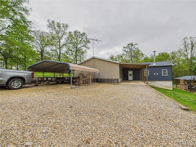 view of front of home with driveway and a carport