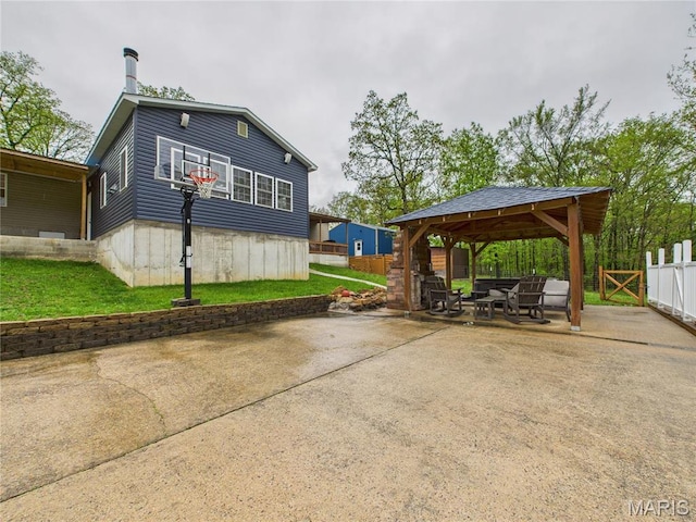 view of side of home with a gazebo, a patio area, driveway, and a detached carport