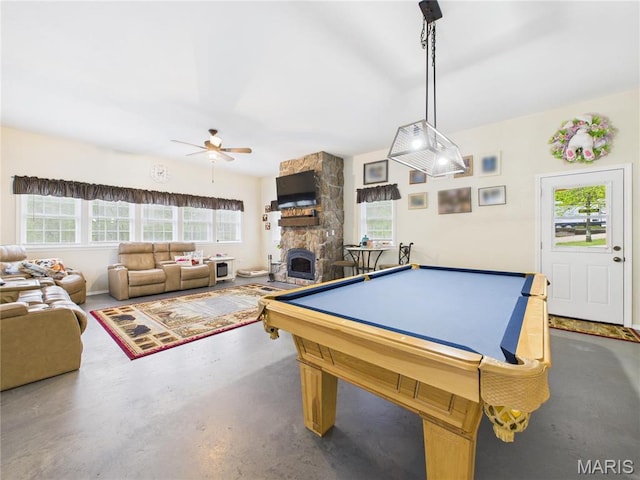 rec room with a ceiling fan, concrete flooring, a fireplace, and pool table