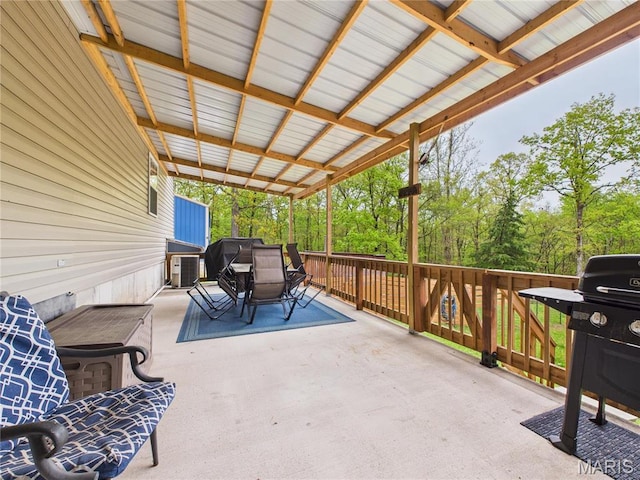 view of patio / terrace with outdoor dining area, area for grilling, and cooling unit