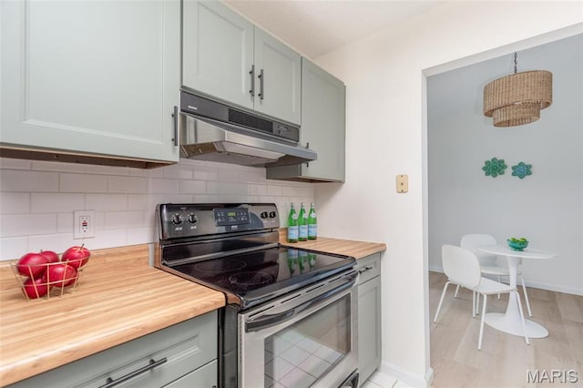 9162 Eager Rd, Saint Louis, MO 63144 - kitchen with stainless steel range with electric cooktop, under cabinet range hood, butcher block counters, and decorative backsplash