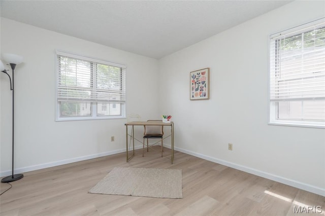 9162 Eager Rd, Saint Louis, MO 63144 - home office with plenty of natural light, wood finished floors, and baseboards