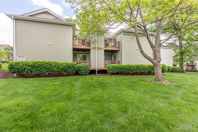 9162 Eager Rd, Saint Louis, MO 63144 - rear view of house featuring a lawn
