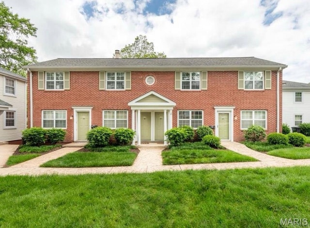 9162 Eager Rd, Saint Louis, MO 63144 - view of front of home featuring a front lawn, brick siding, and a chimney