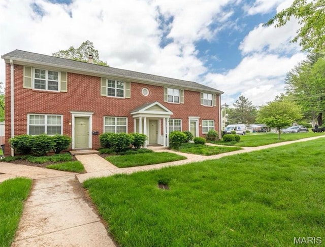 9162 Eager Rd, Saint Louis, MO 63144 - view of front facade with a front lawn, a chimney, and brick siding