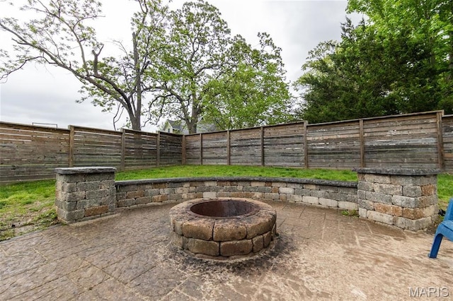 view of patio with a fire pit and a fenced backyard