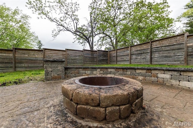 view of patio / terrace featuring an outdoor fire pit and a fenced backyard